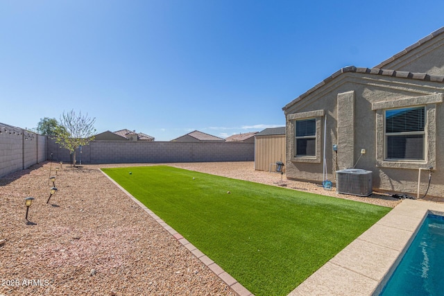 view of yard with a fenced backyard, a fenced in pool, and central air condition unit