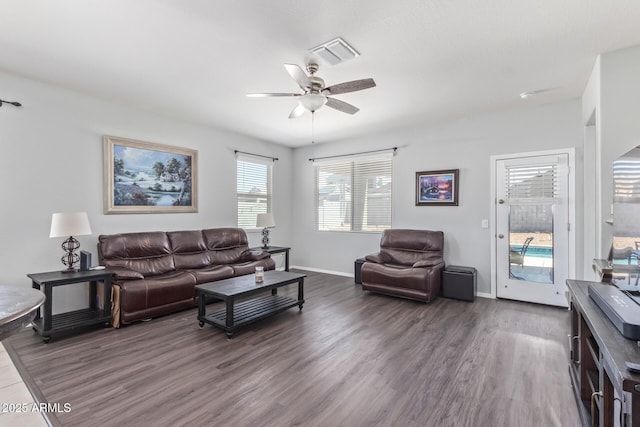 living room with baseboards, ceiling fan, visible vents, and wood finished floors