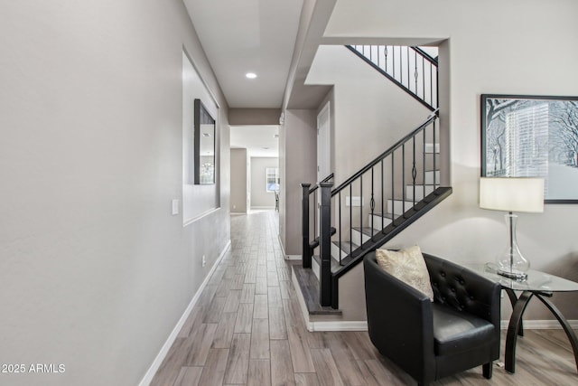 corridor with light hardwood / wood-style floors