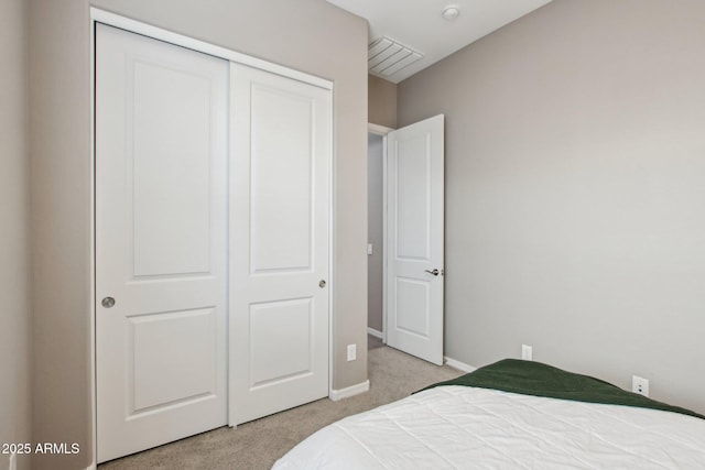 carpeted bedroom featuring a closet