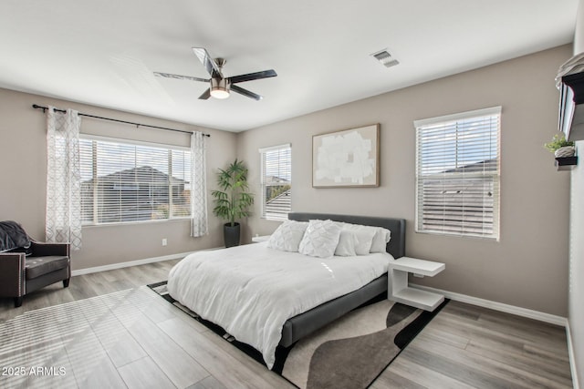 bedroom featuring light hardwood / wood-style floors and ceiling fan