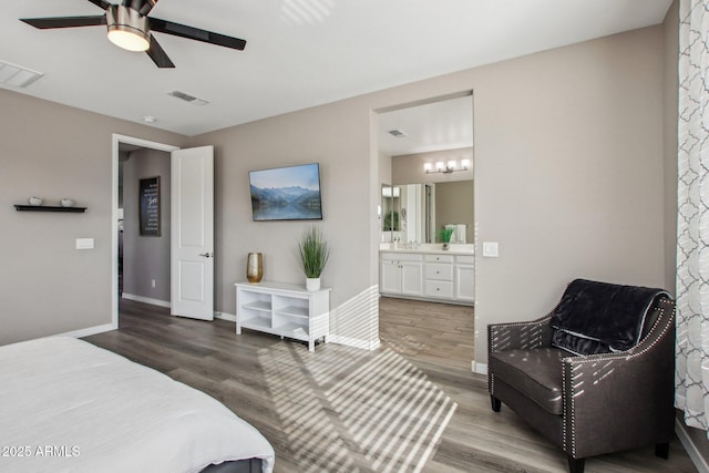 bedroom featuring ceiling fan, connected bathroom, and hardwood / wood-style floors