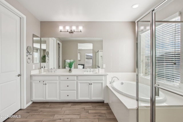 bathroom featuring vanity, shower with separate bathtub, and plenty of natural light