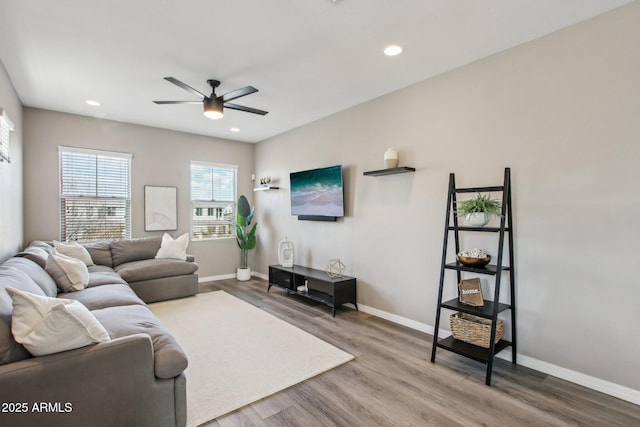 living room featuring hardwood / wood-style flooring and ceiling fan