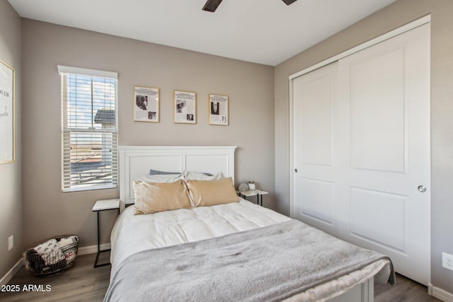 bedroom featuring hardwood / wood-style floors, a closet, and ceiling fan