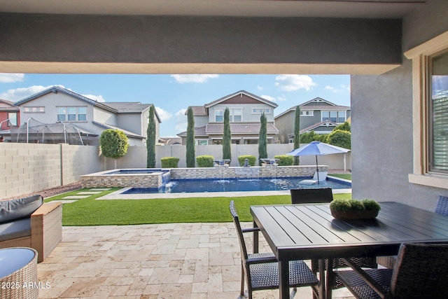 view of patio / terrace featuring pool water feature and a pool with hot tub