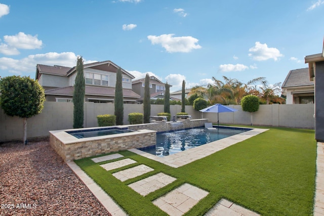 view of swimming pool featuring a lawn, pool water feature, and an in ground hot tub