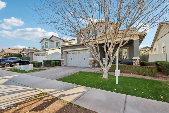 view of front of home featuring a garage and a front yard