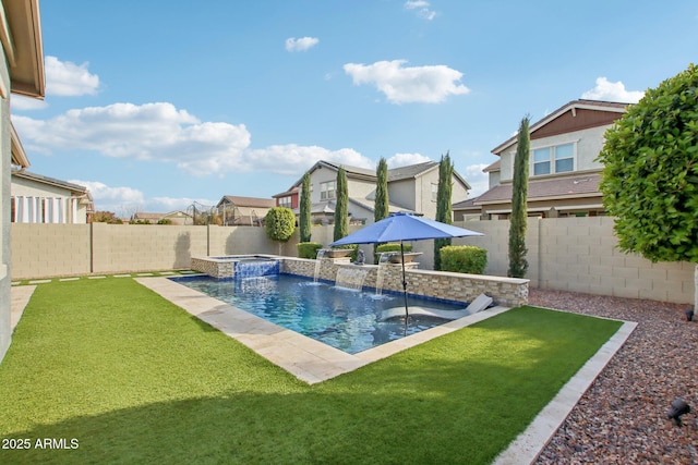 view of pool with a yard, pool water feature, and an in ground hot tub