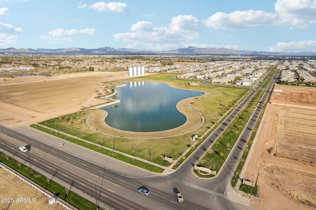 birds eye view of property with a water and mountain view