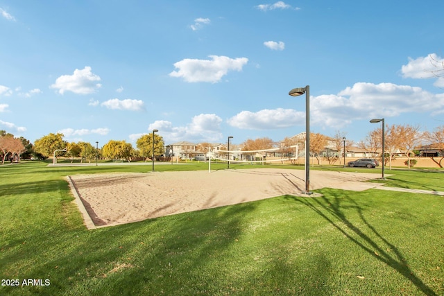 view of community featuring volleyball court and a lawn