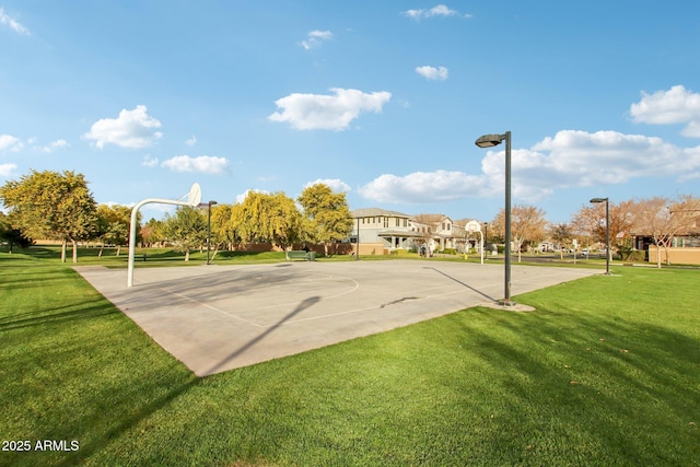 view of sport court featuring a lawn