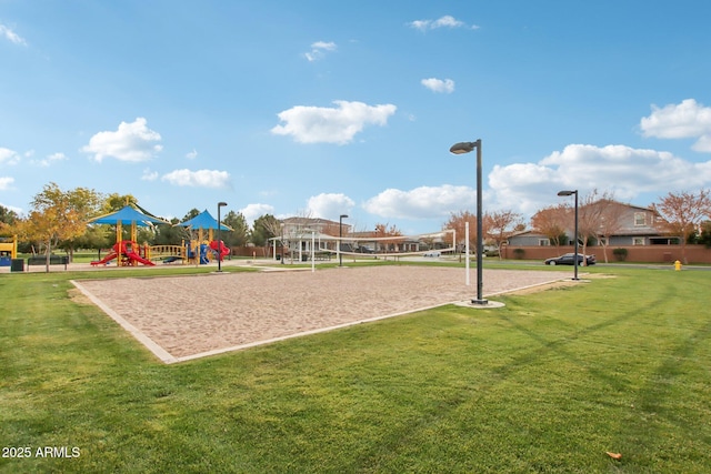 surrounding community featuring a playground, volleyball court, and a lawn