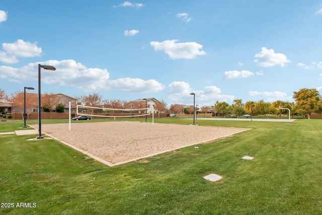 view of property's community featuring a yard and volleyball court