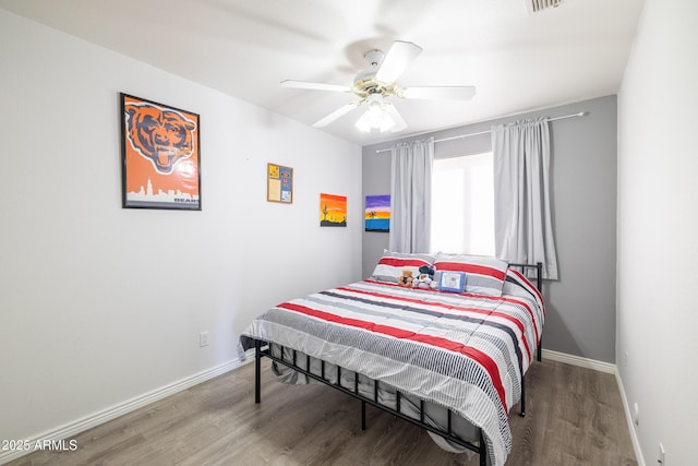 bedroom with ceiling fan and hardwood / wood-style flooring