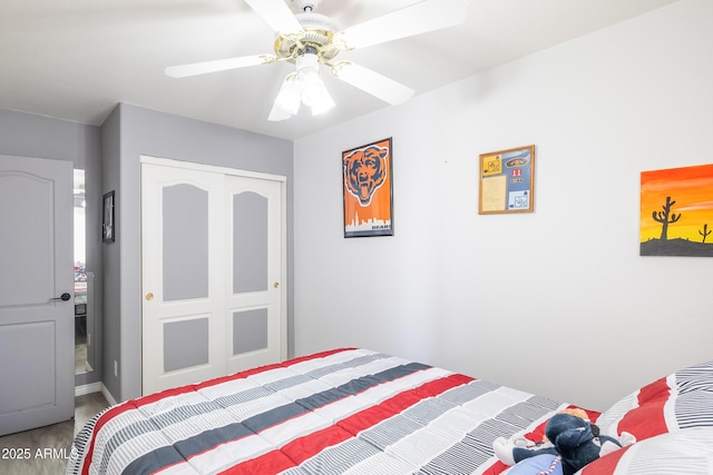 bedroom with ceiling fan and a closet