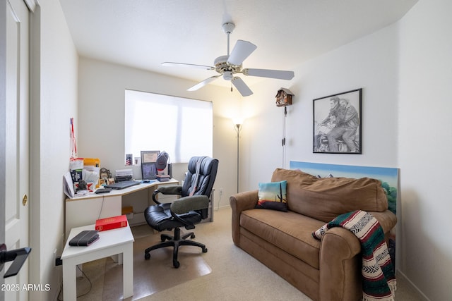 carpeted office featuring ceiling fan