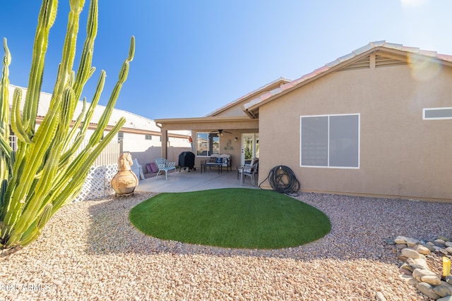 back of property featuring a patio area and ceiling fan