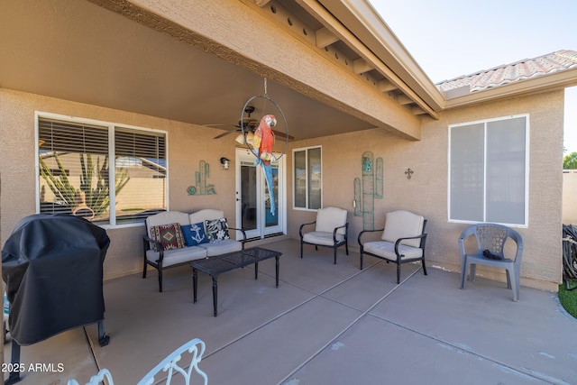 view of patio / terrace featuring grilling area, ceiling fan, and an outdoor living space