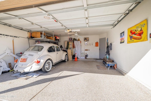 garage with a garage door opener and ceiling fan