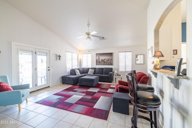 living room with ceiling fan, high vaulted ceiling, and light tile patterned floors