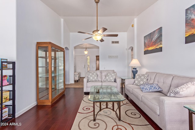 living room featuring ceiling fan, dark hardwood / wood-style flooring, and a high ceiling