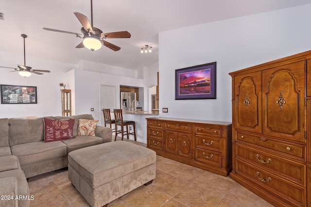 tiled living room featuring sink and ceiling fan