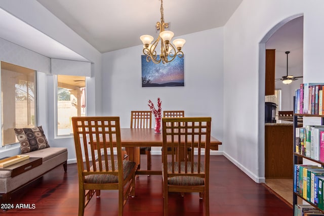 dining space featuring vaulted ceiling, ceiling fan with notable chandelier, and dark hardwood / wood-style flooring