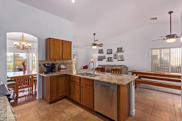 kitchen with kitchen peninsula, dishwasher, sink, and light tile patterned floors