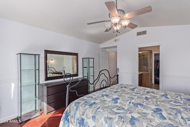 bedroom featuring connected bathroom, ceiling fan, wood-type flooring, and lofted ceiling