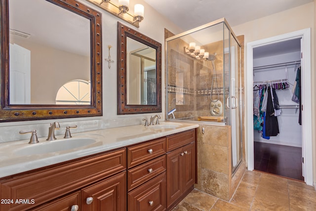 bathroom featuring vanity and a shower with shower door