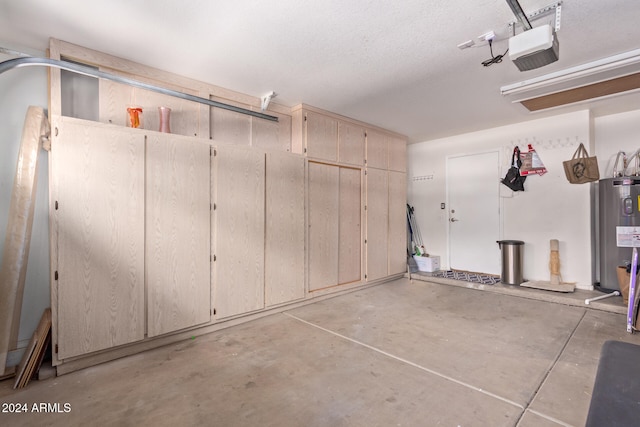 garage with a garage door opener and electric water heater