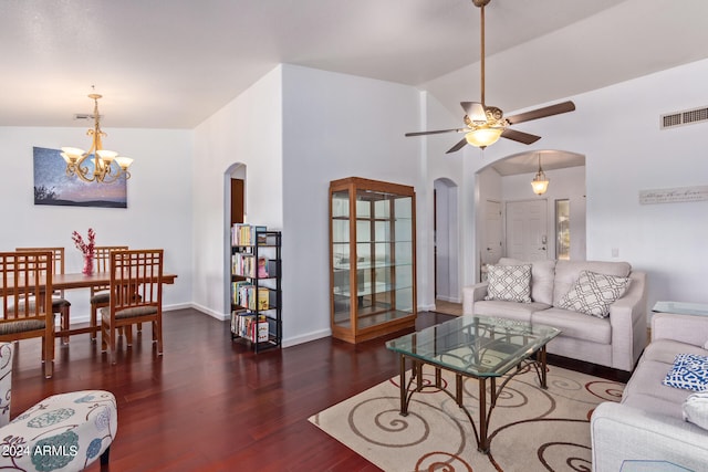 living room with dark wood-type flooring, lofted ceiling, and ceiling fan with notable chandelier