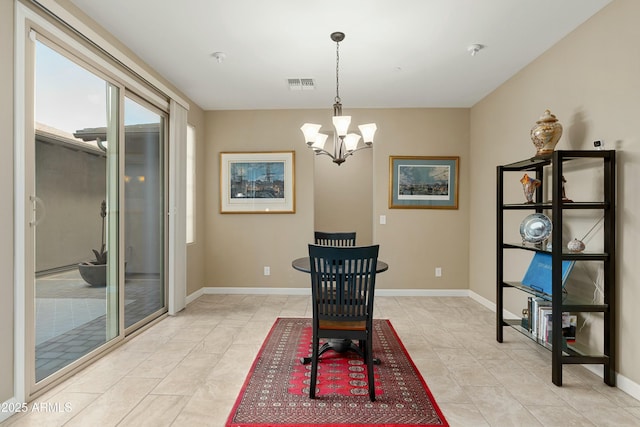 dining room with a chandelier, light tile patterned flooring, visible vents, and baseboards