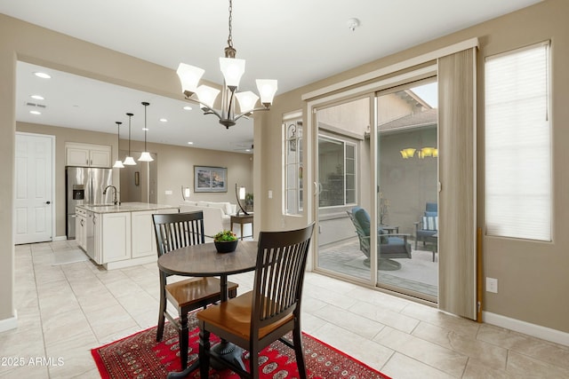 dining space with plenty of natural light, a chandelier, baseboards, and recessed lighting