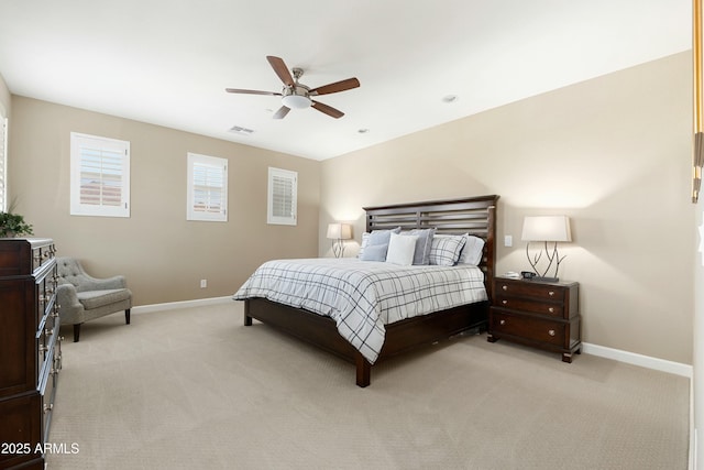 bedroom with baseboards, visible vents, a ceiling fan, and light colored carpet