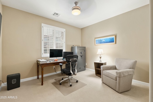 carpeted office with visible vents and baseboards