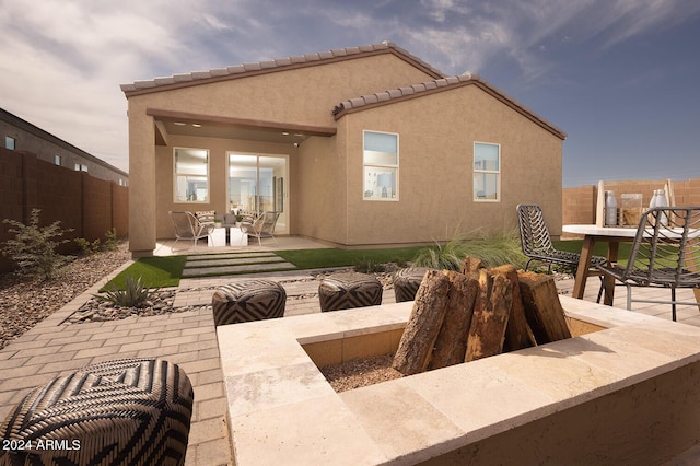 rear view of property with a patio, a fenced backyard, and stucco siding