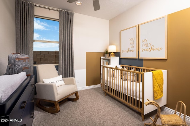 carpeted bedroom featuring a crib, baseboards, a ceiling fan, and recessed lighting