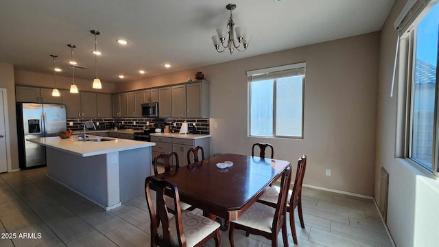 dining space featuring sink and a chandelier