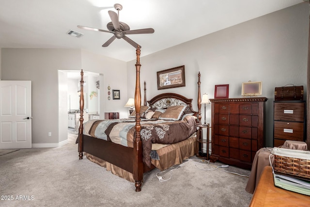 bedroom featuring visible vents, ceiling fan, baseboards, carpet floors, and ensuite bath