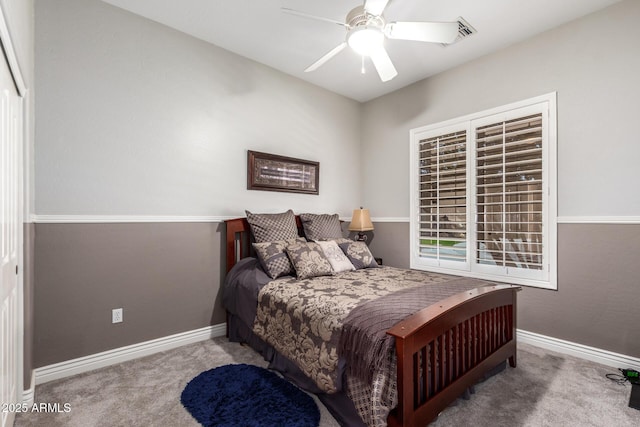 carpeted bedroom with ceiling fan and baseboards