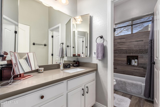 full bathroom featuring toilet, vanity, shower / tub combination, and wood finished floors