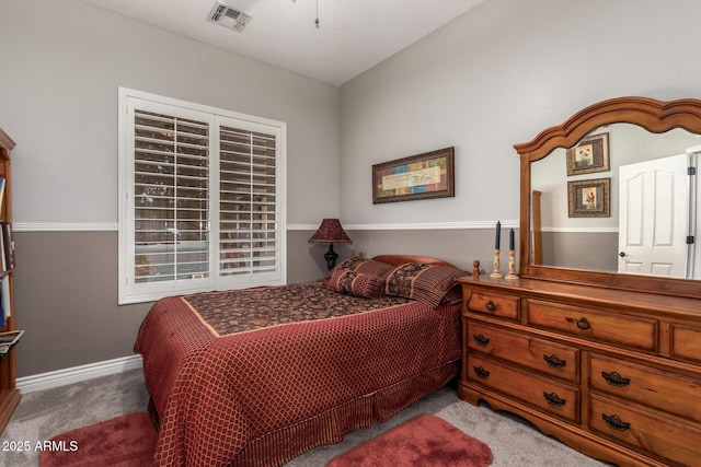 carpeted bedroom featuring baseboards and visible vents