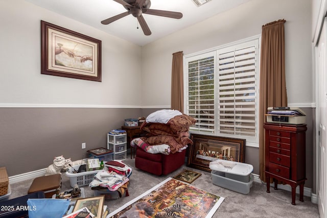 living area featuring a ceiling fan, carpet, visible vents, and baseboards