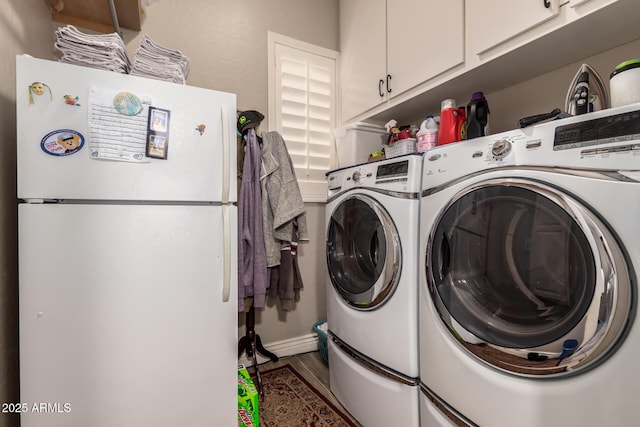 laundry area with washing machine and dryer and cabinet space