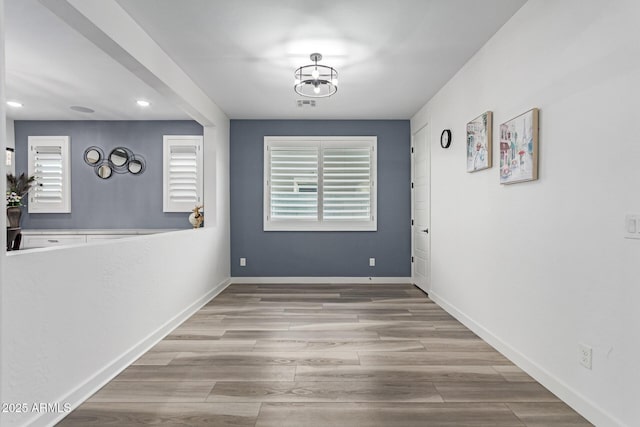 1501 E Rakestraw Ln, Gilbert, AZ 85298 - unfurnished dining area with recessed lighting, healthy amount of natural light, wood finished floors, and baseboards