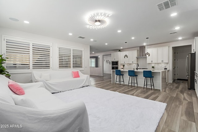 1501 E Rakestraw Ln, Gilbert, AZ 85298 - living area with light wood-style floors and recessed lighting