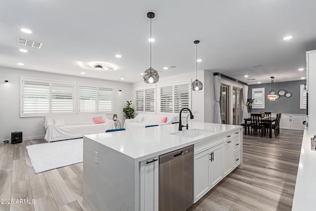 1501 E Rakestraw Ln, Gilbert, AZ 85298 - kitchen with stainless steel dishwasher, a sink, a kitchen island with sink, recessed lighting, and open floor plan
