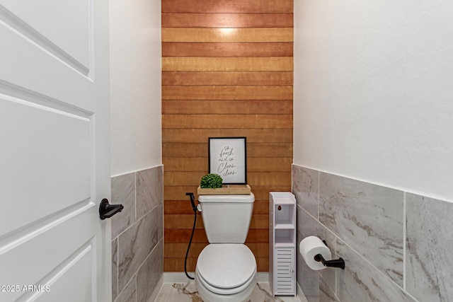 1501 E Rakestraw Ln, Gilbert, AZ 85298 - bathroom featuring tile walls, toilet, and a wainscoted wall